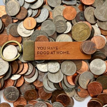 scattering of coins with key chain in center with "you have food at home".
