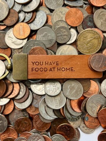 scattering of coins with key chain in center with "you have food at home".