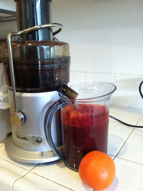 homemade juice in pitcher by juicer