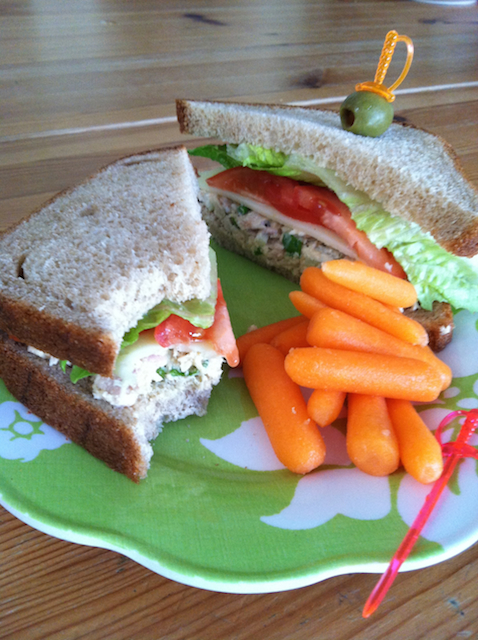 tuna salad sandwich cut in half on a plate