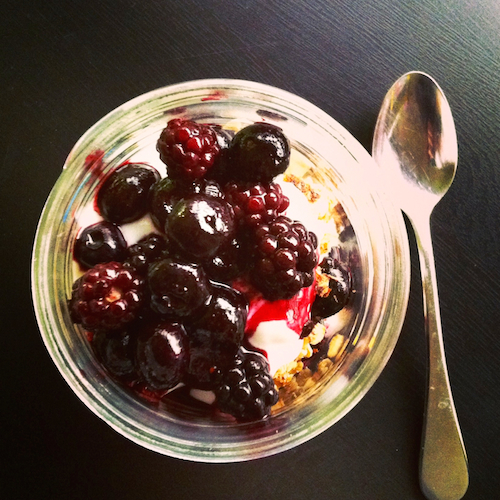 yogurt parfait in jar topped with berries