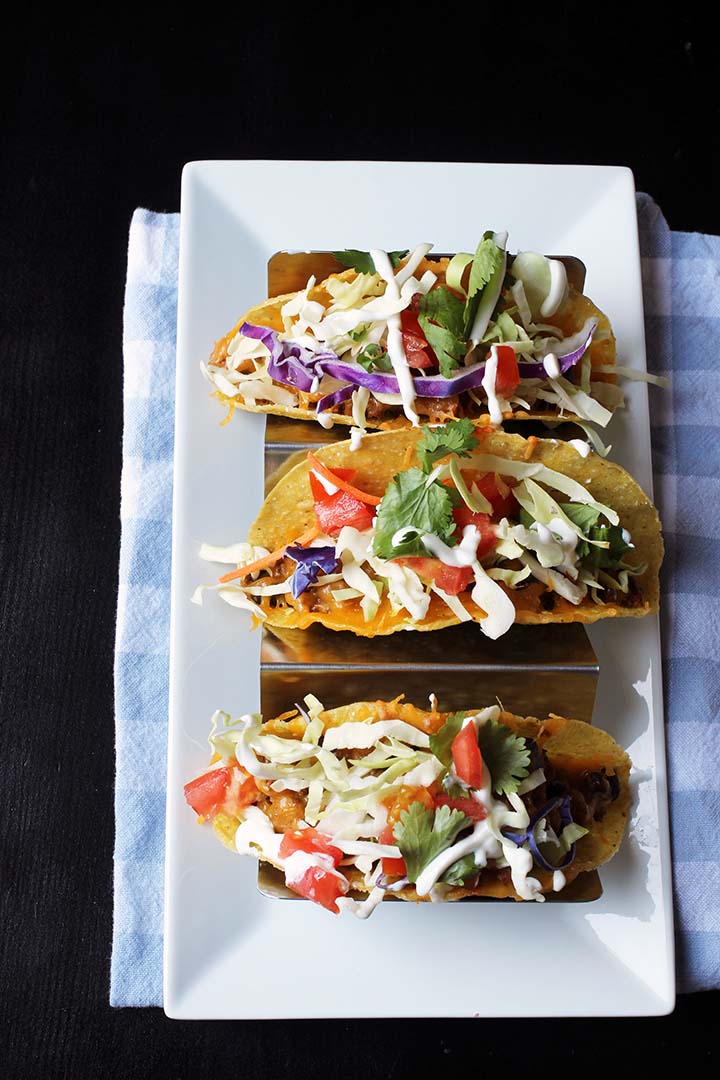 aerial view of three turkey and black bean tacos in rack