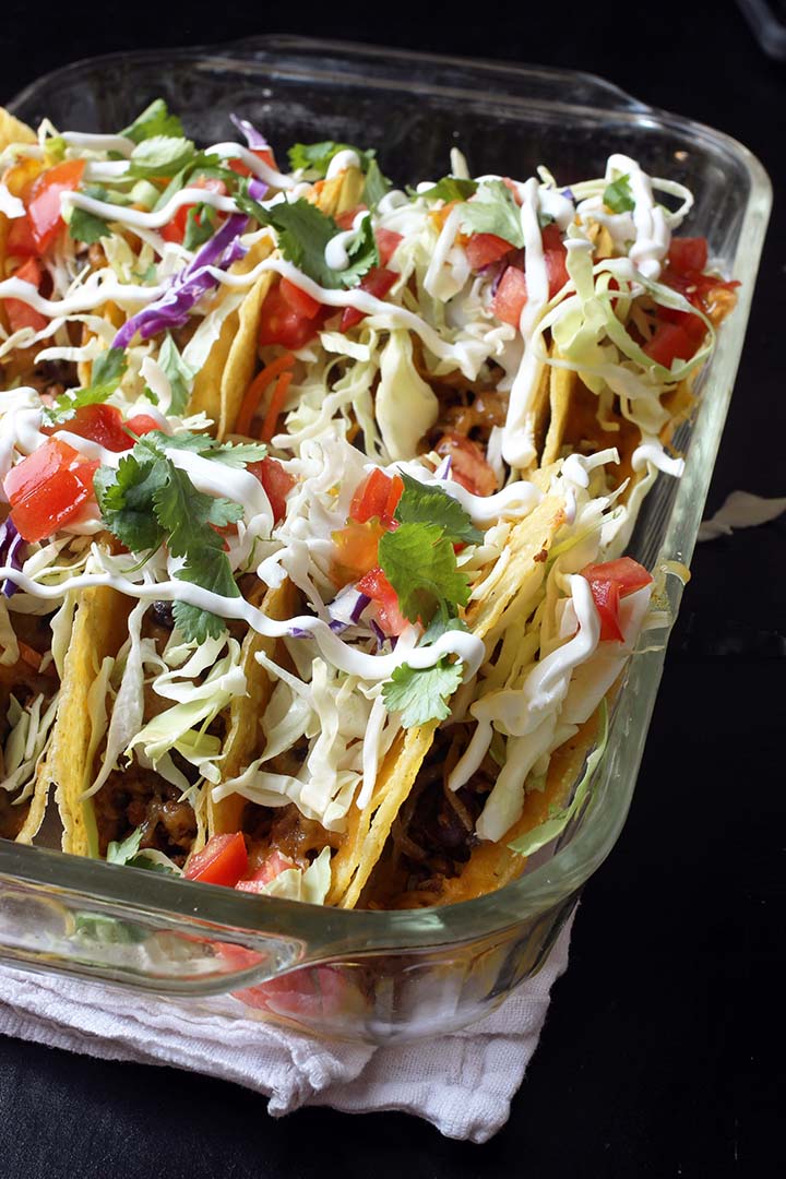 pyrex pan filled with tacos with toppings