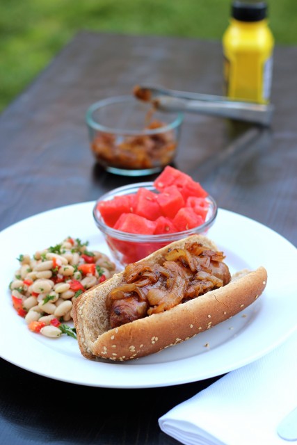 A plate of food on a table, with Hot dog and sides