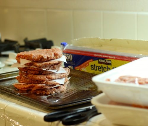 A stack of burgers on plastic wrap
