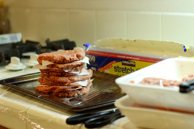 A stack of burgers on plastic wrap