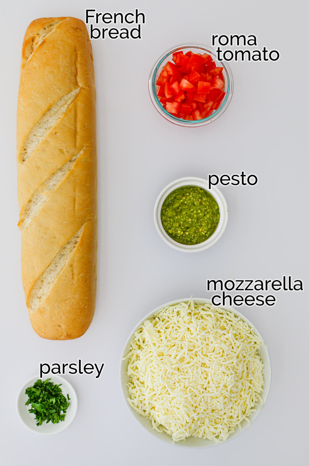 ingredients for french bread pizza on white counter.