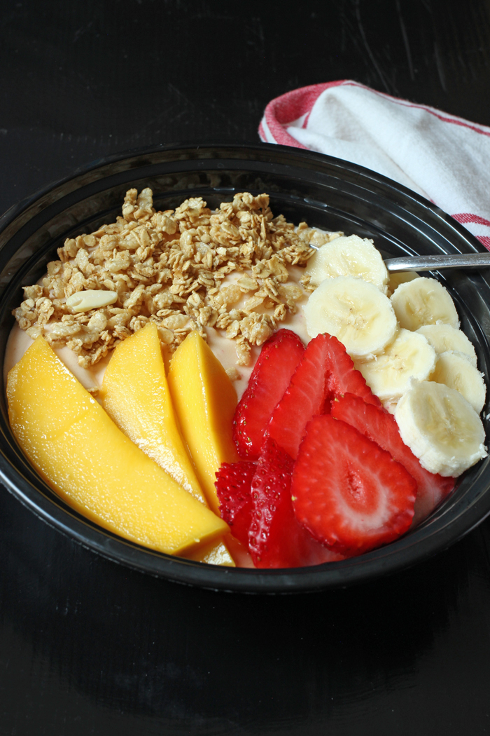 smoothie bowl with mango, granola, banana, and strawberries