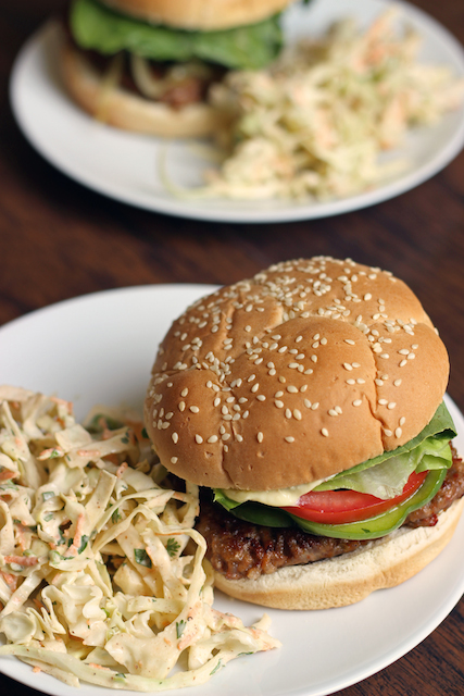 sausage burger on a plate, with coleslaw