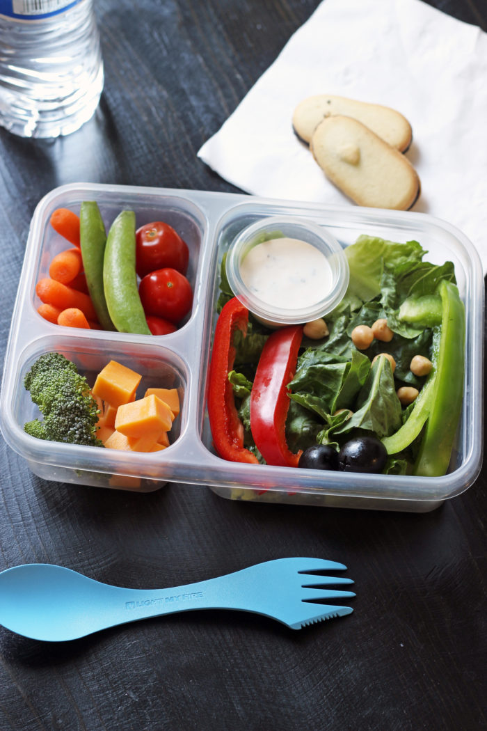 boxed lunch with veggies and dip, cheese and fruit