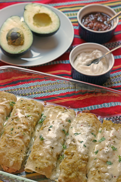 pan of chicken enchiladas with toppings