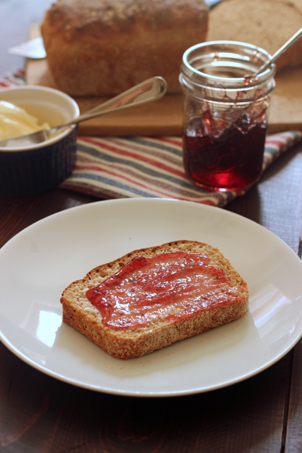 a slice of muffin bread on plate with jam