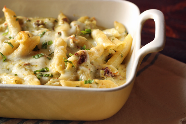 A pan of baked pesto pasta and cheese