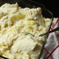 mashed potatoes in a glass dish with spoon