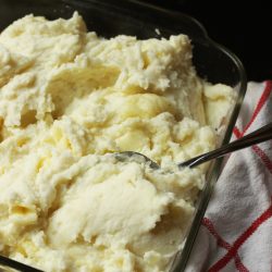 mashed potatoes in a glass dish with spoon