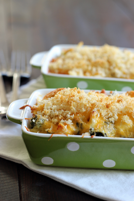 Two small green polka dot casserole dishes of chicken divan.