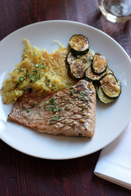 A plate of sweet potatoes and fish on a table