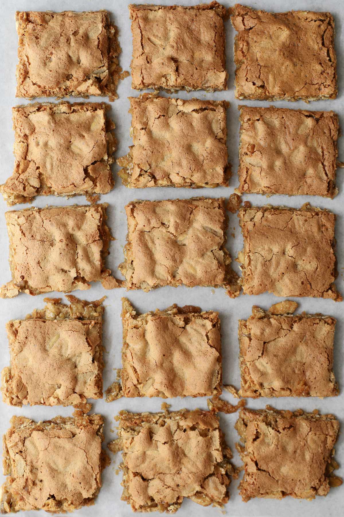 brown sugar bars cut into squares on parchment paper.