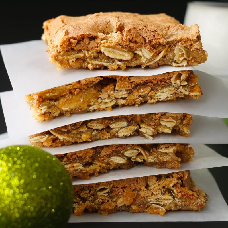 stack of brown sugar bars divided by parchment paper squares.