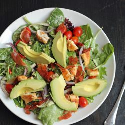a plate of salad with avocados