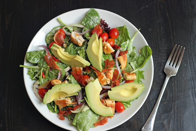 a plate of salad with avocados