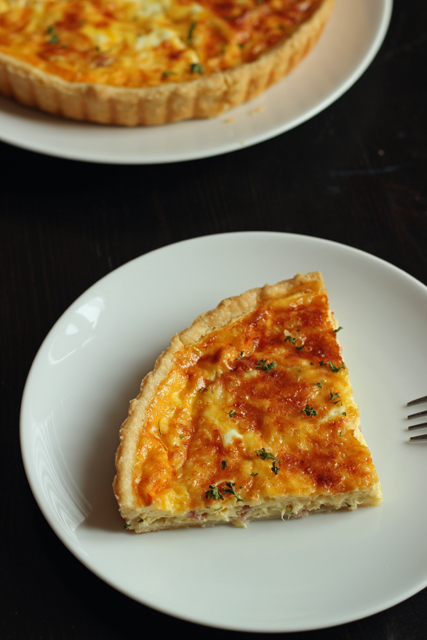 Slice of Ham and Gruyere Quiche with Leeks on a plate