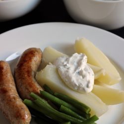 Sausage and Potatoes with Sour Cream Sauce on a plate