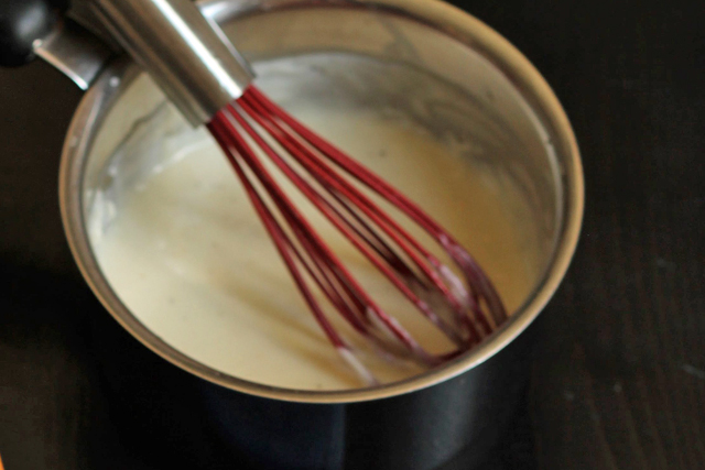 A close up of saucepan of white sauce