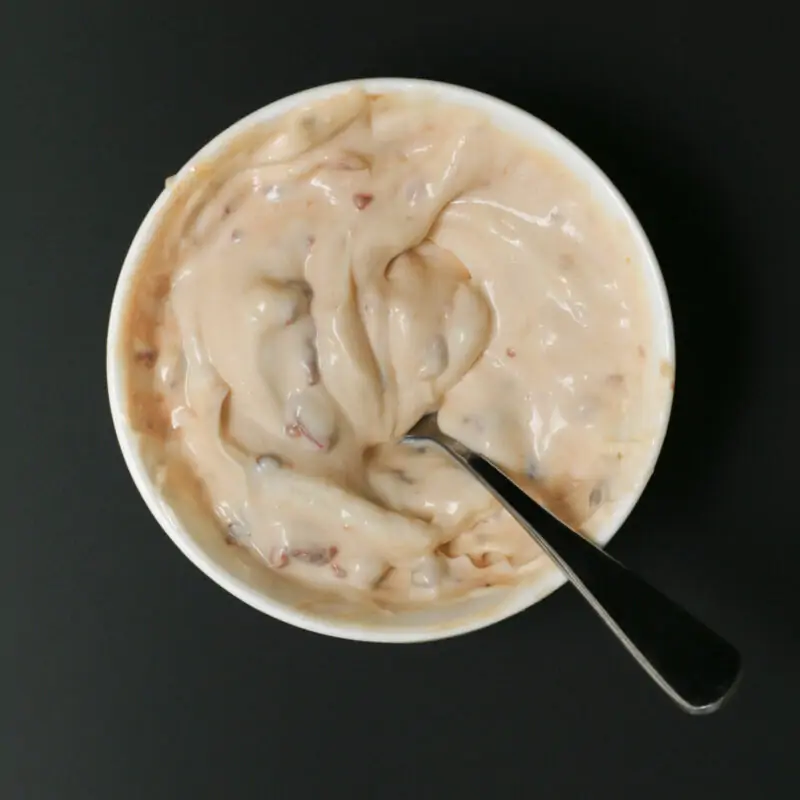 overhead shot of a bowl of chipotle mayo with a spoon swirling it.