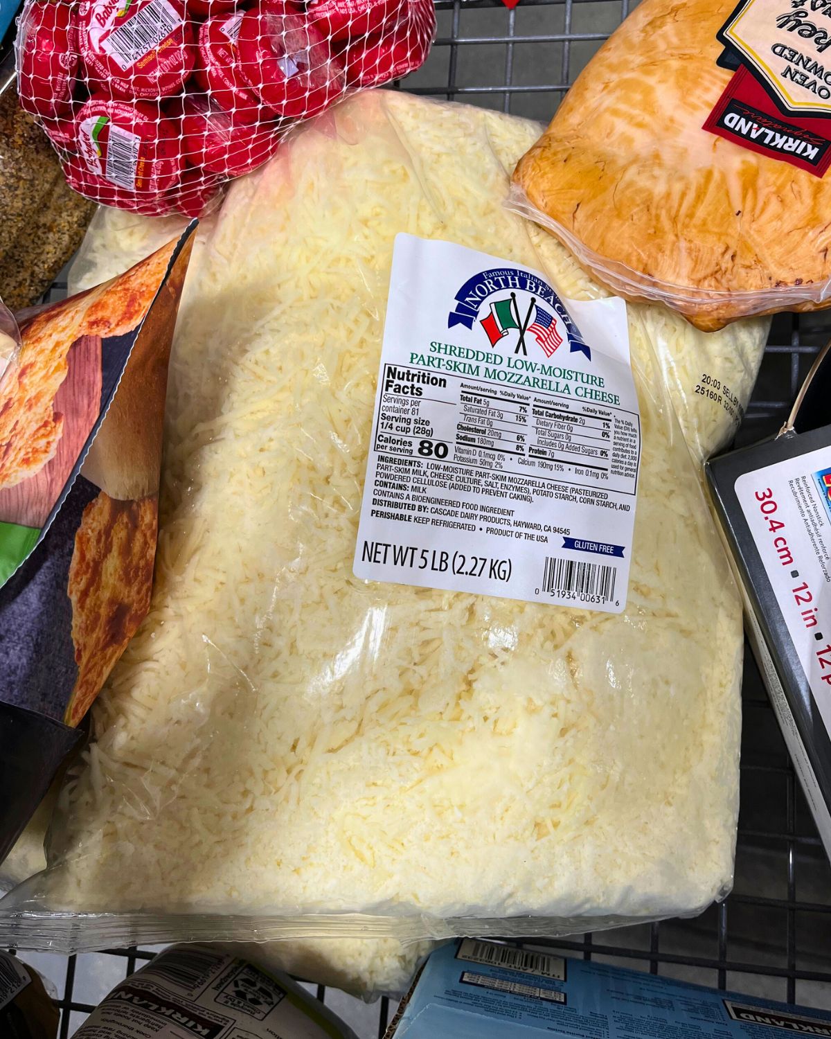 bag of shredded mozzarella in costco cart.