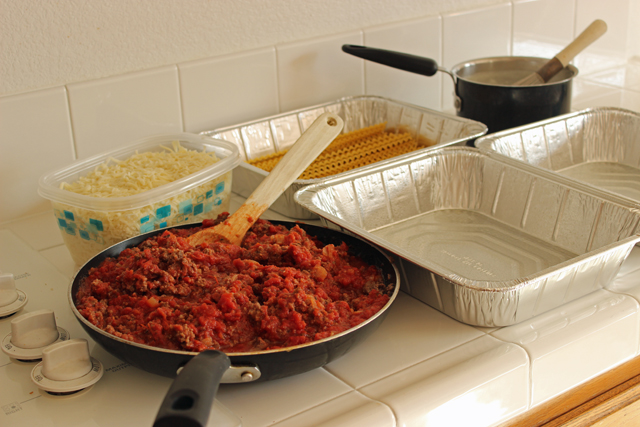 Ingredients and containers on a counter to freeze lasagna