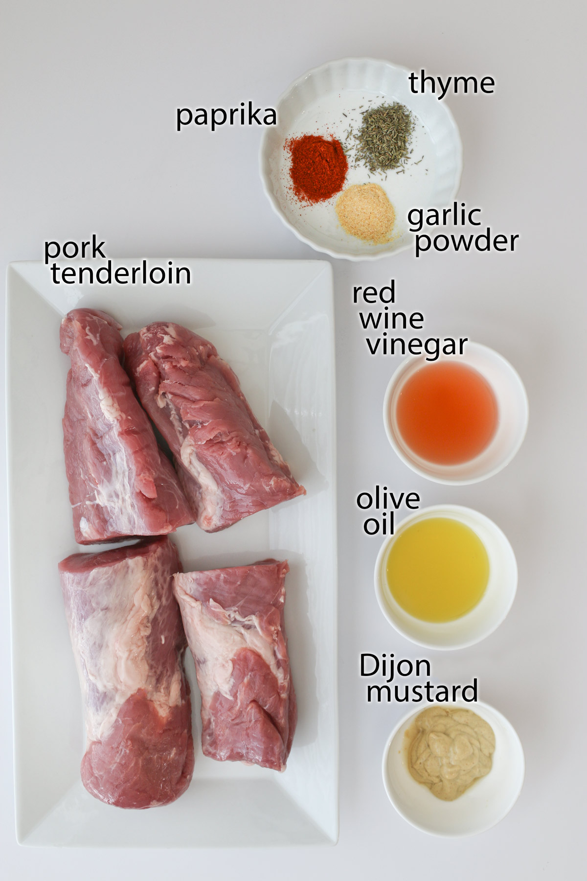 ingredients to make air fryer pork tenderloin laid out on a white countertop.