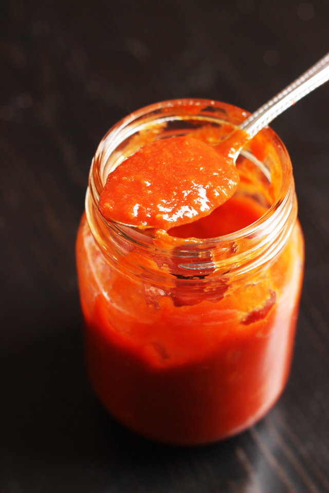 spoonful of sauce resting on jar