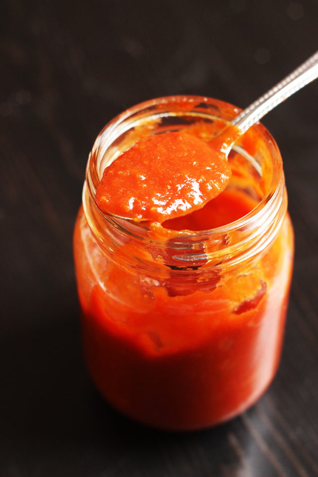 mason jar of bbq sauce with a spoon in it