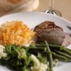 A plate of steak, potatoes, and veggies