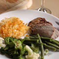 A plate of steak, potatoes, and veggies