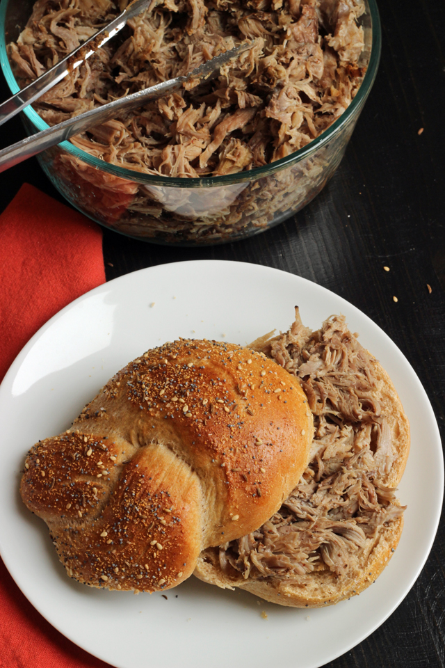 a plate with a pulled pork sandwich