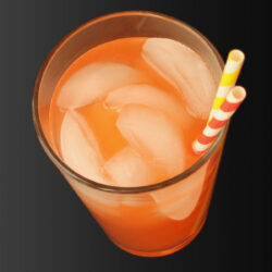 glass of pink lemonade with ice and straws