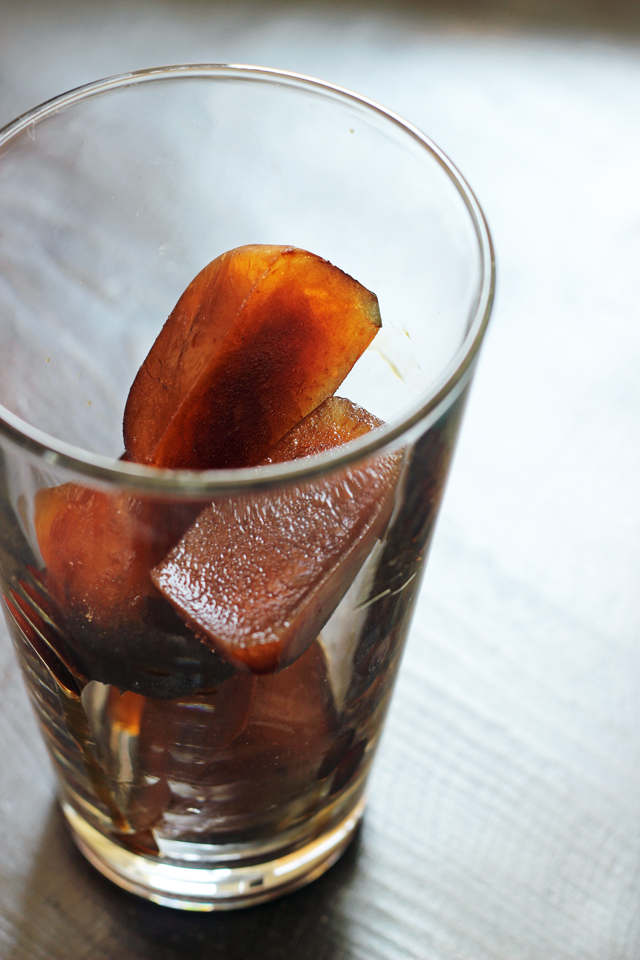 A glass of frozen coffee cubes