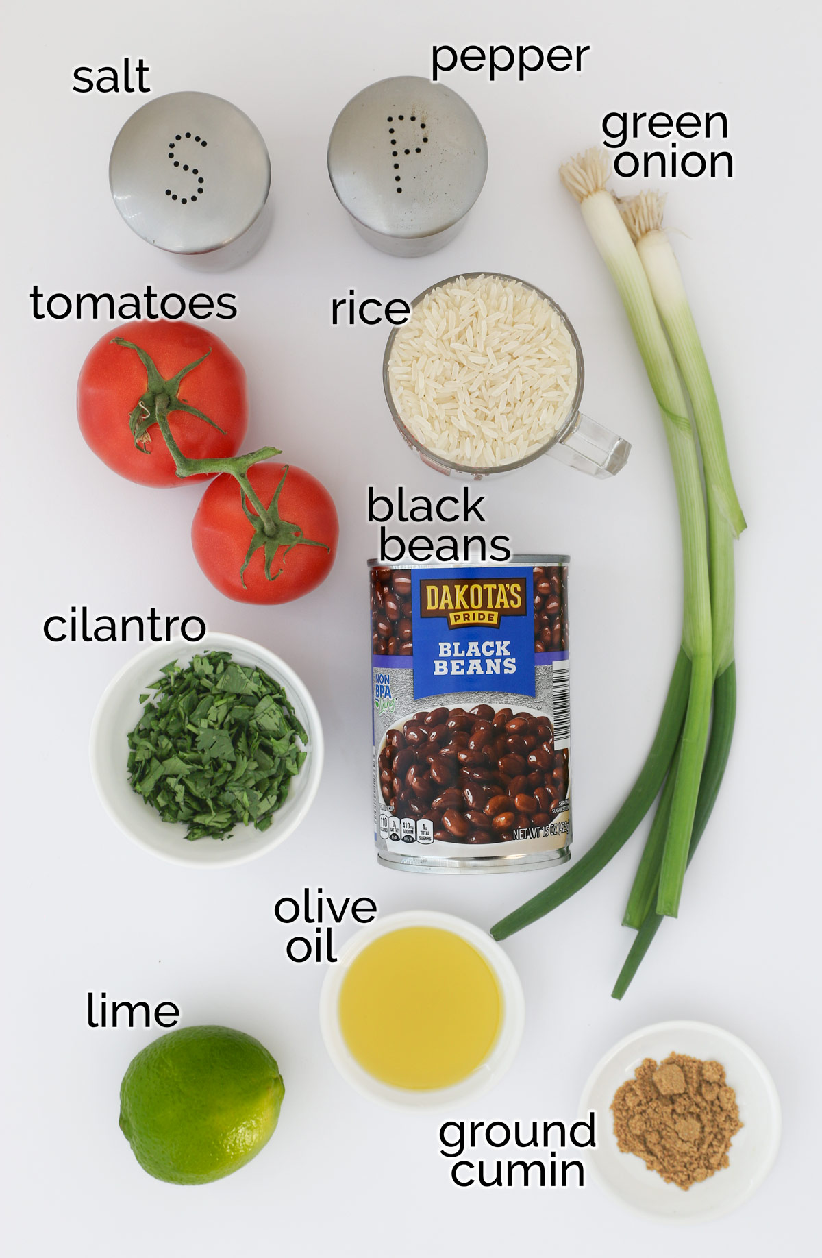 ingredients to make black bean salad laid out on a white counter.