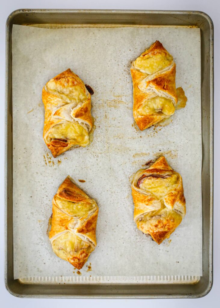 the baked croissants on the parchment-lined tray.