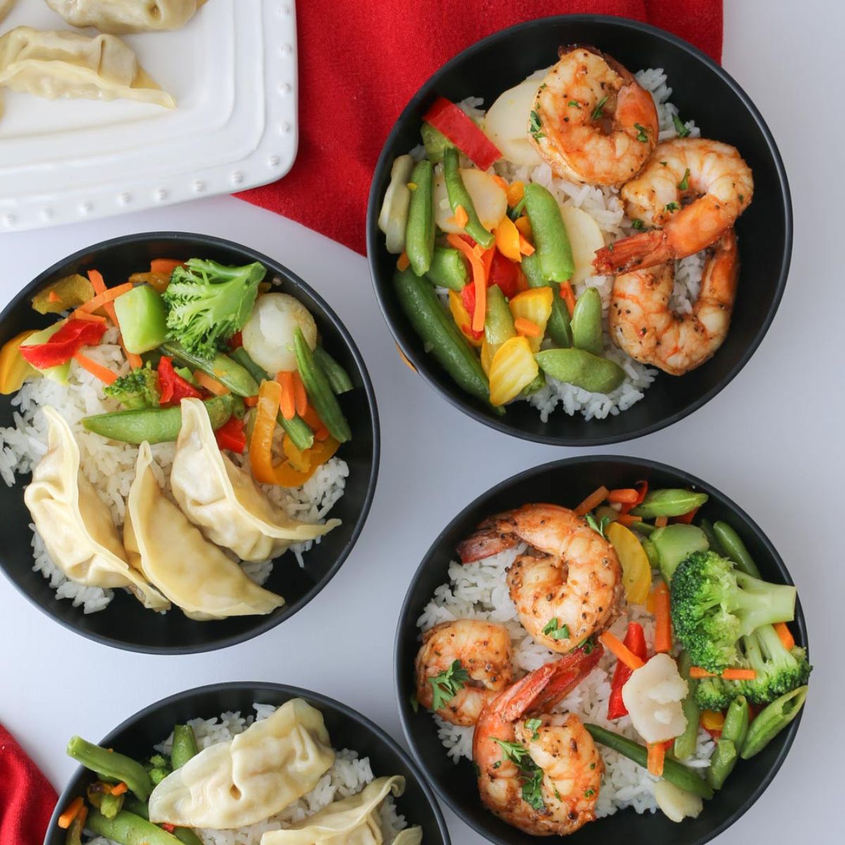 array of rice bowls in black bowls on table.