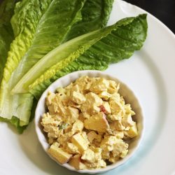 dish of chicken curry salad with lettuce leaves