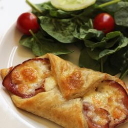 ham and cheese fold-over on plate with salad