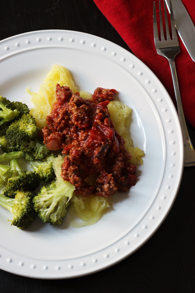 A plate of squash with meat sauce and broccoli