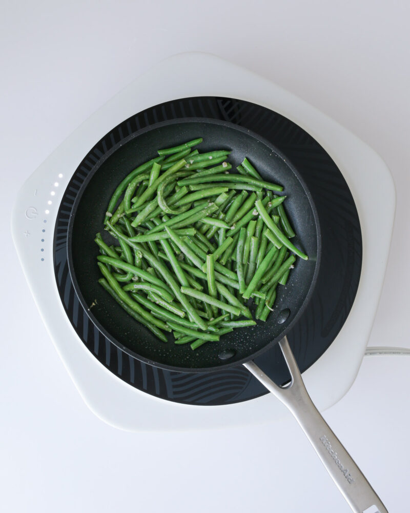 sauteed green beans in the skillet.