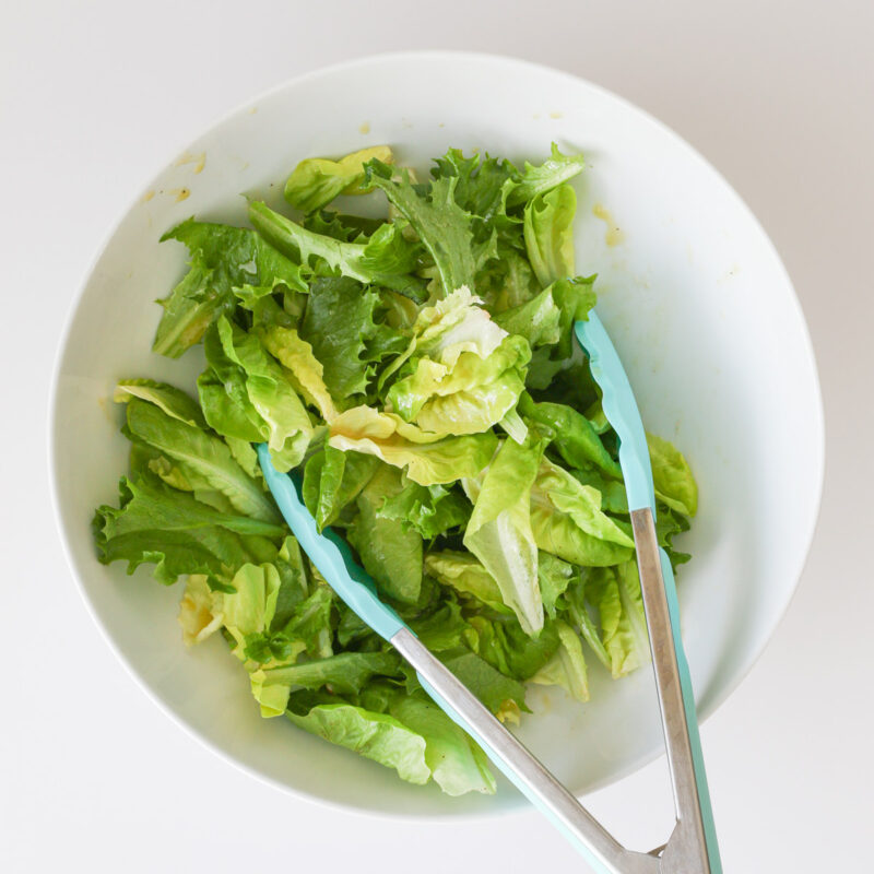 lettuce leaves in large white bowl.