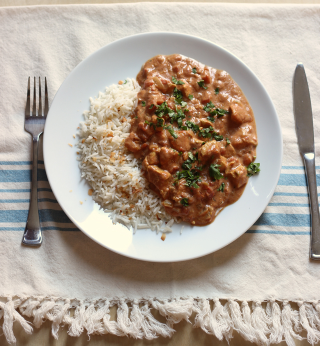 A plate of chicken tikka masala and rice