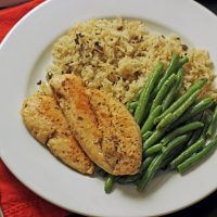 chicken, rice and green beans on a dinner plate