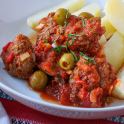 close up of Catalan meatballs over potatoes.